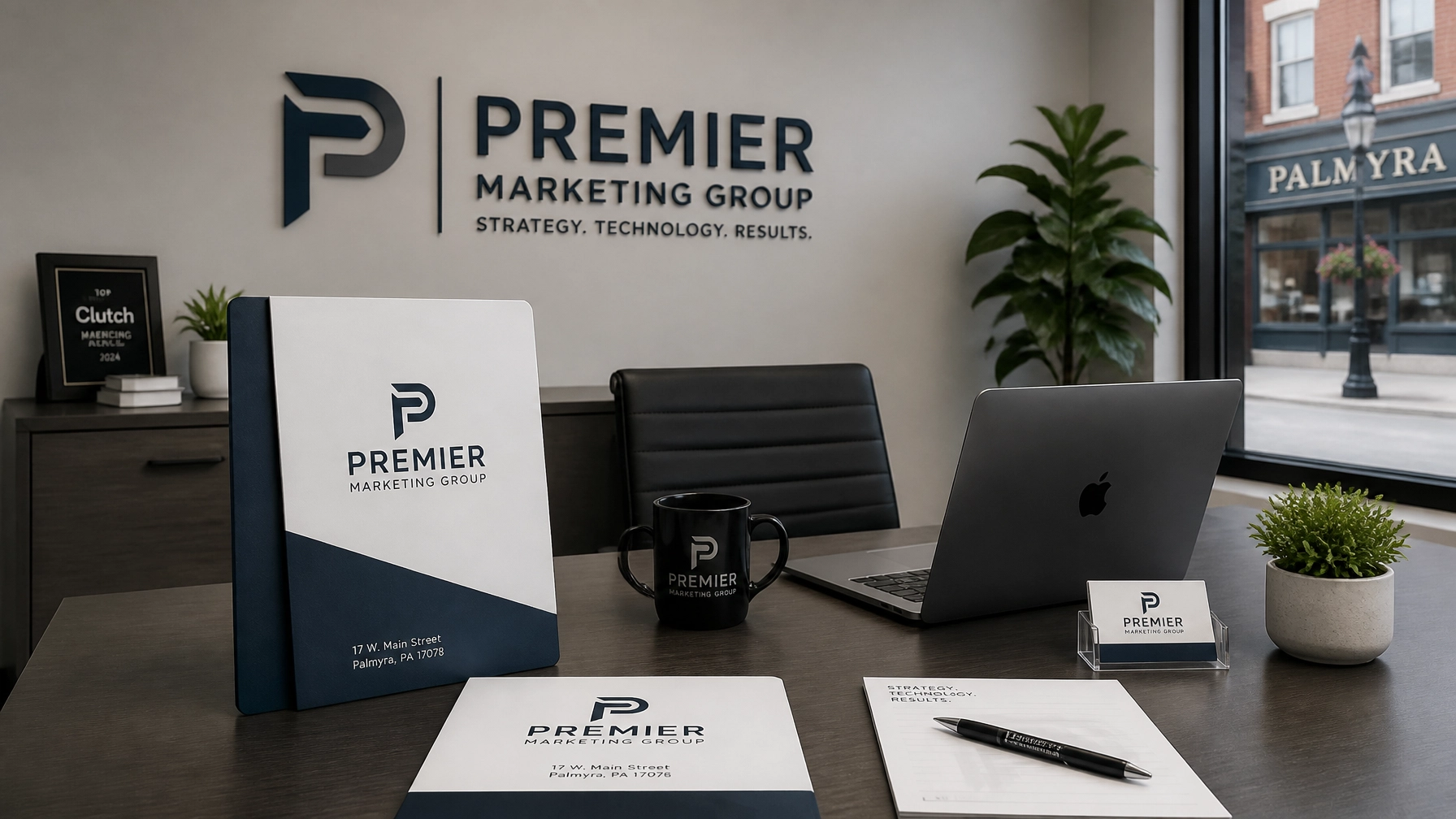 Professional marketing consultation desk in Palmyra, PA featuring folders with the address 17 W. Main Street, Palmyra, PA 17078 and Premier Marketing Group branding